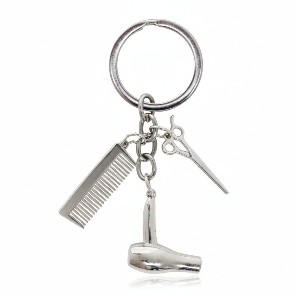 Metal keychain with comb, hair dryer, and scissors on a white background